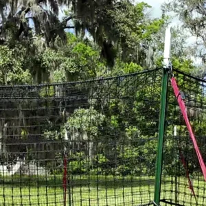 16:9 landscape close-up of The P.I.G. Hog Trap™ showing the support pole, bracket hardware, net attachment strap, and portable wild hog trapping system designed for feral hog control and complete sounder removal.